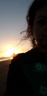 Portrait of silhouette woman on beach against sky during sunset