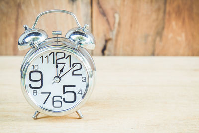 Close-up of alarm clock on table