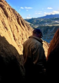 Rear view of rock formations against sky
