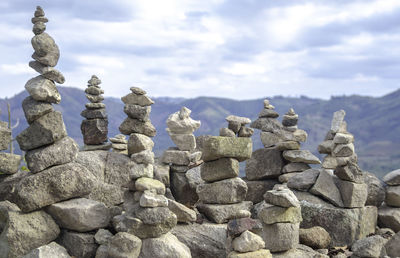 Stone stack on rocks against sky