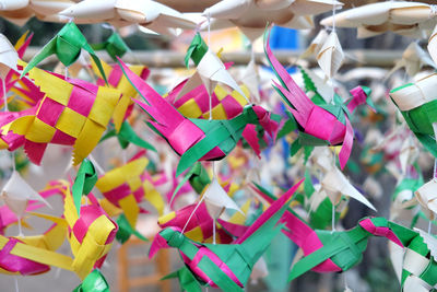 Close-up of multi colored umbrellas hanging on paper