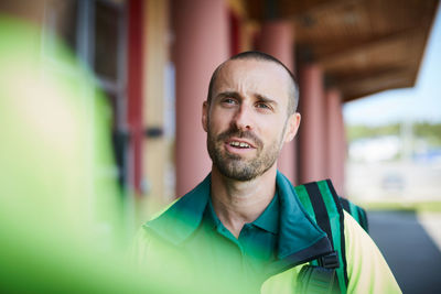 Male paramedic in uniform looking away outside hospital