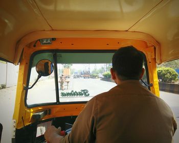 Rear view of man driving rickshaw