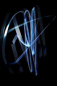 Low angle view of light painting against black background