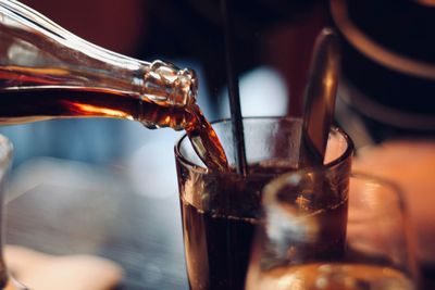 Close-up of wine pouring coffee in glass