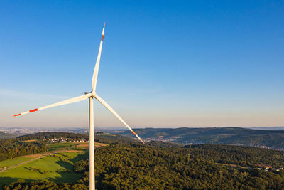 Germany, baden-wurttemberg, aerial view of wind turbine at dawn