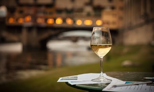 Wine on table against bridge over river