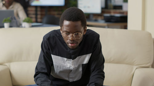 Young man sitting at home