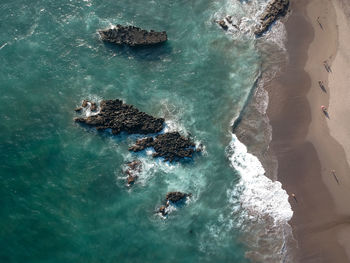 High angle view of rocks in sea