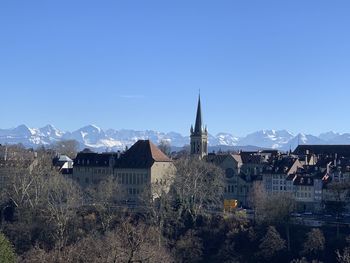 Buildings in city against clear sky