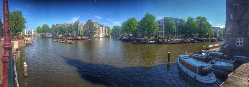 Boats in river with buildings in background