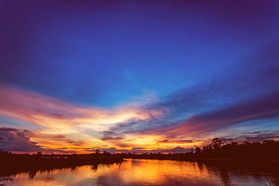 Scenic view of lake against romantic sky at sunset