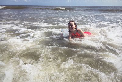 Cute girl enjoying in sea at beach