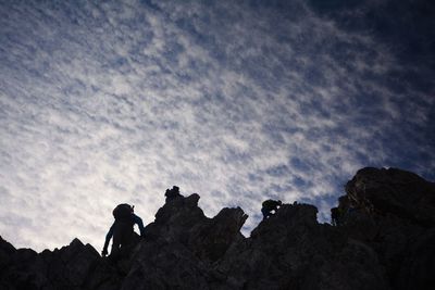 Low angle view of silhouette rocks on mountain against sky