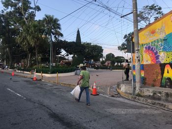 Rear view of people on street in city