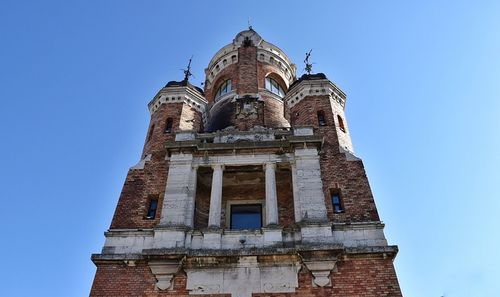 Low angle view of building against clear blue sky