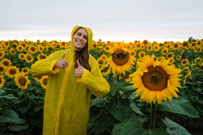 Full length of yellow sunflower on field against sky