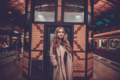 Portrait of woman standing on railroad station