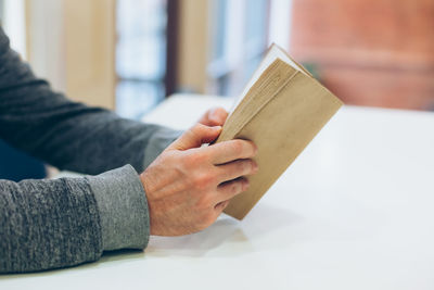 Close-up of hand holding book