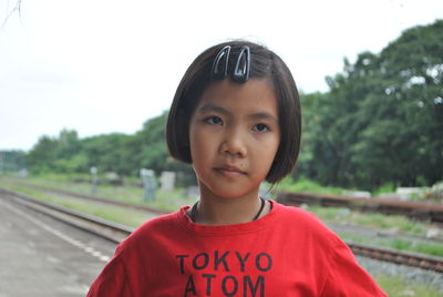 Portrait of girl against trees