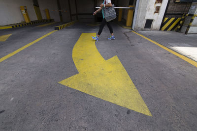 Low section of woman on road