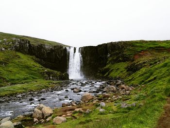 Scenic view of waterfall against clear sky