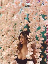 Portrait of smiling woman with pink flowers