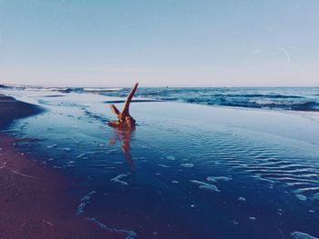 Woman jumping on beach