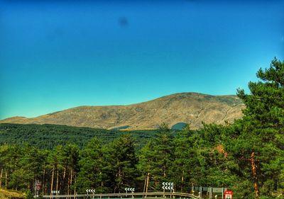 Scenic view of mountains against clear blue sky