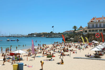 Panoramic view of beach and buildings against clear sky