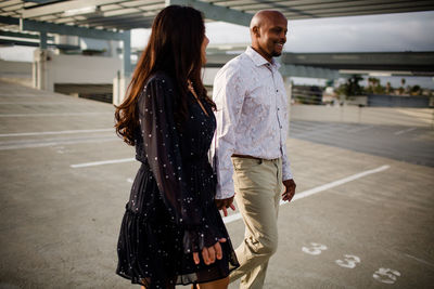 Couple walking with umbrella standing on floor