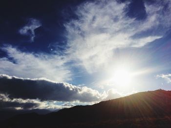 Scenic view of mountains against cloudy sky