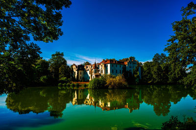 Güttmannsdorf castle, a neo-gothic castle on a small lake in dobrocin, poland.