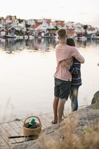 Romantic couple embracing on pier at lake