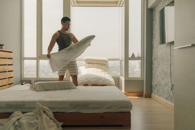 Man adjusting bed at home