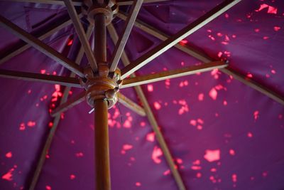 Low angle view of chain swing ride at night