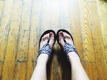 Low section of woman on hardwood floor