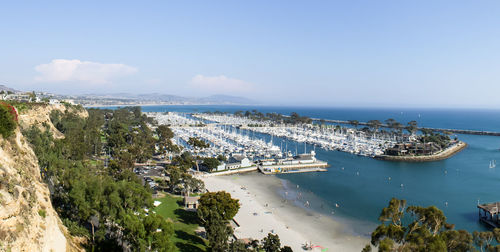 High angle view of town by sea against sky