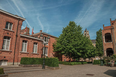 Peaceful courtyard, trees and old buildings in bruges. a town full of canals   in belgium.