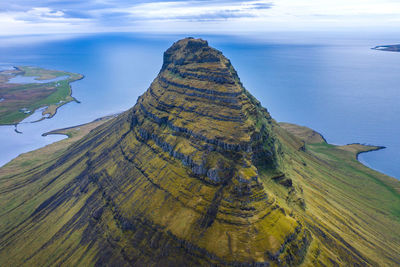 High angle view of rock formation by sea against sky