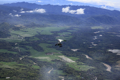 The microlight trike passes over the green and the iconic river, progo river, kulonprogo.