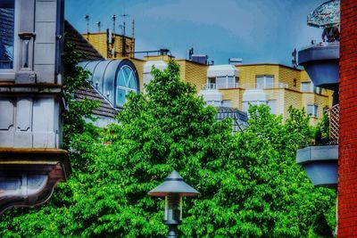 Residential building by street against sky