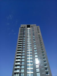 Low angle view of modern building against clear blue sky