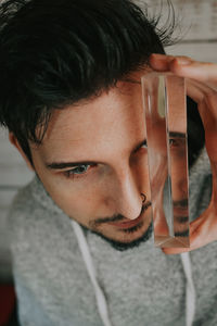 Close-up portrait of young man drinking glass