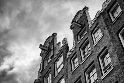 Low angle view of building against cloudy sky