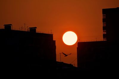 Low angle view of building against sky at sunset