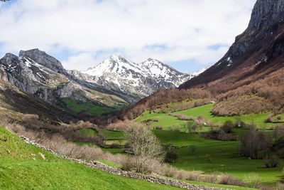 Scenic view of mountains against cloudy sky