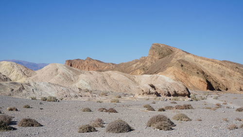 Scenic view of rocky mountains against clear blue sky