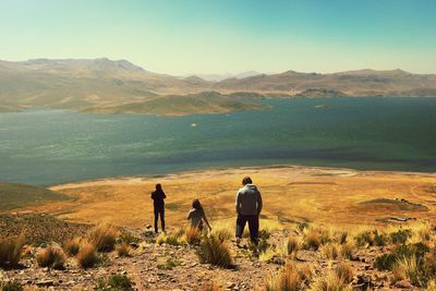 Woman standing on mountain against sky