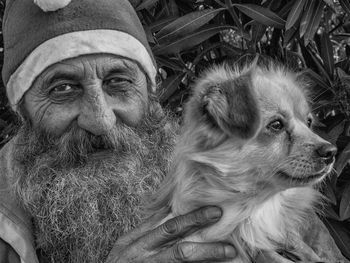 Close-up portrait of senior man with dog